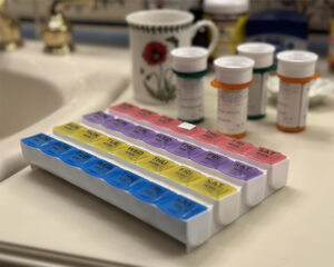 Medication management container on private bathroom counter