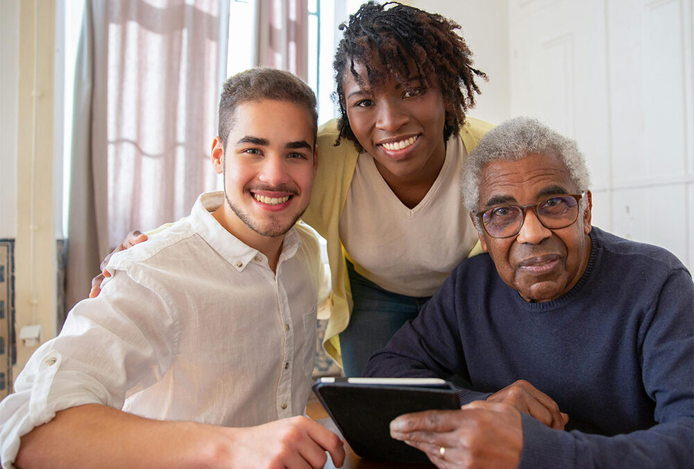 Caregivers smiling with in-home-care client