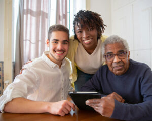 Caregivers smiling with in-home-care client